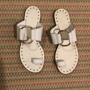 Tory Burch white sandals with gold ring.